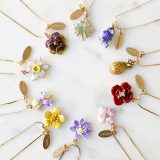 A variety of Erwin Pearl plant and flower necklaces.